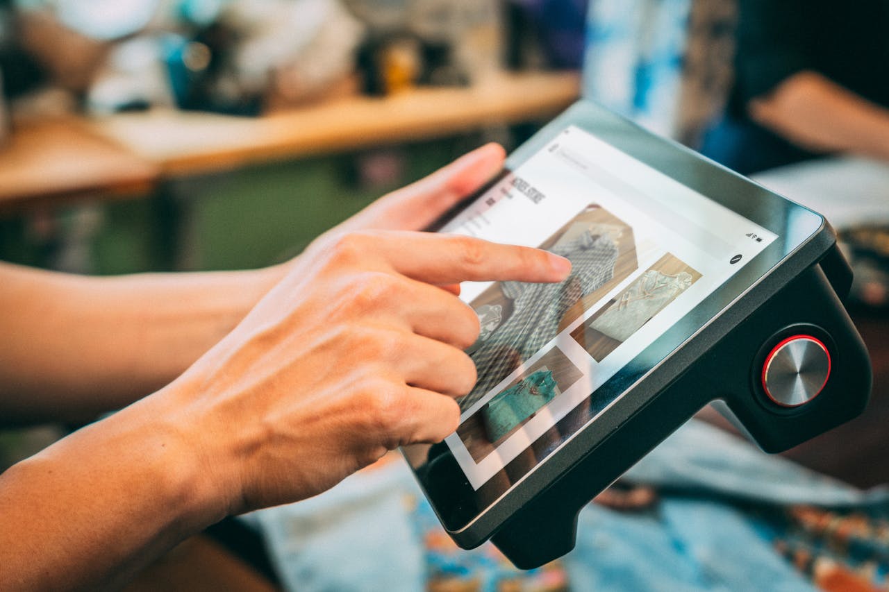 Close-up of hands interacting with a touchscreen device, showcasing digital content.